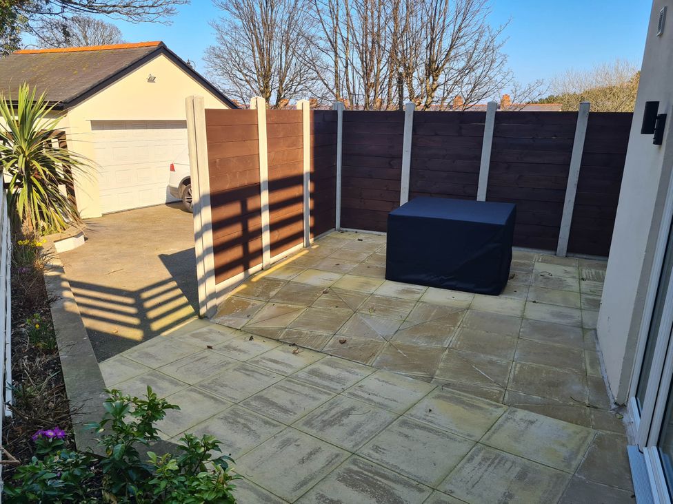 An outdoor area with paving, a storage box, and a fence at Conwy Charm Cottage 3 Bed Retreat Penmaenmawr