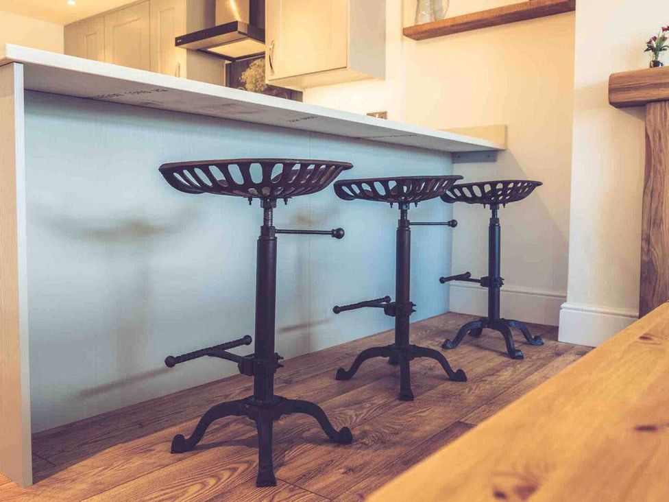 Three bar stools at a counter in a kitchen at 3Bed Cottage Plymouth Dog friendly Sleeps7, Plymouth