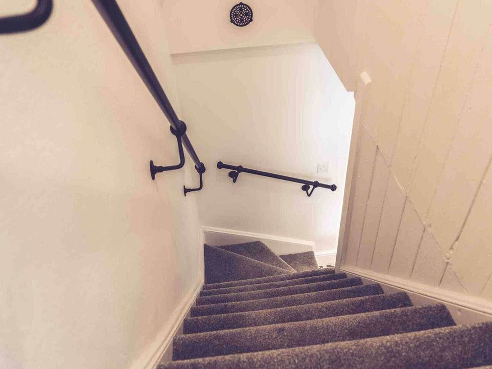 A staircase with a handrail and carpet at 3Bed Cottage Plymouth Dog friendly Sleeps7 Plymouth