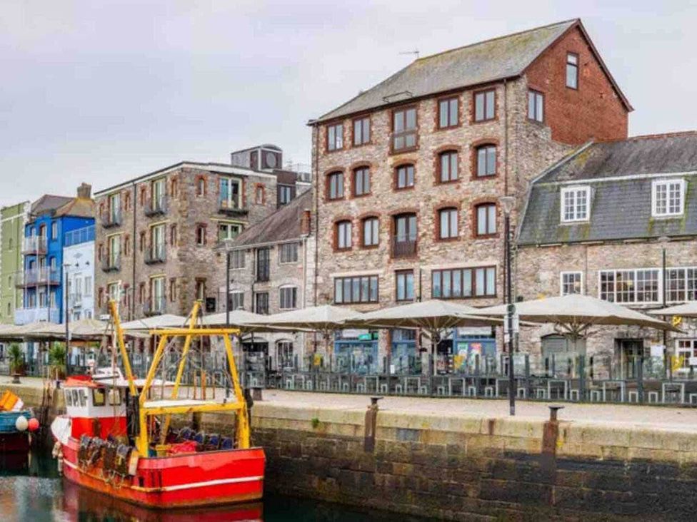 A harbor with buildings and a boat at 3Bed Cottage Plymouth Dog friendly Sleeps7 Plymouth