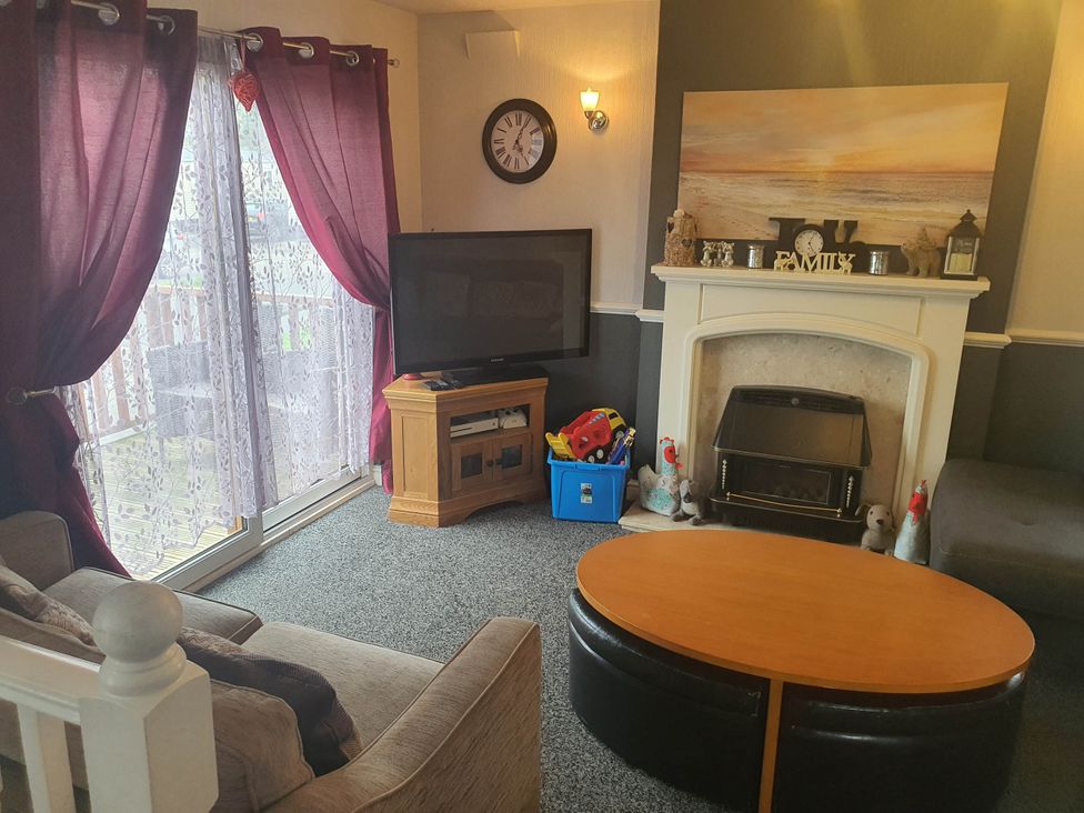 A living room with a sofa and television at the property in Fleetwood