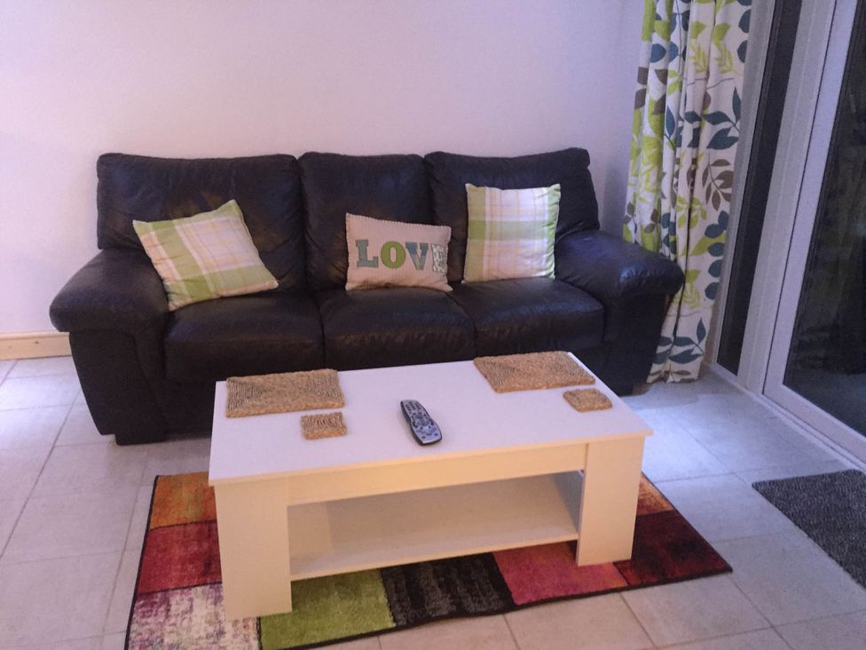 A living room with a sofa and coffee table at Tanygrisiau near Blaenau Ffestiniog