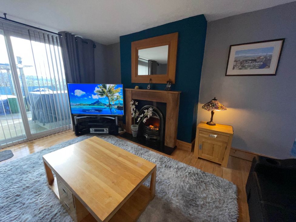 A living room with a television and a fireplace at Tanygrisiau near Blaenau Ffestiniog