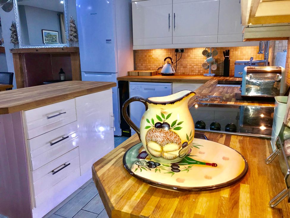 A kitchen with various appliances and a decorative pitcher at Tanygrisiau near Blaenau Ffestiniog