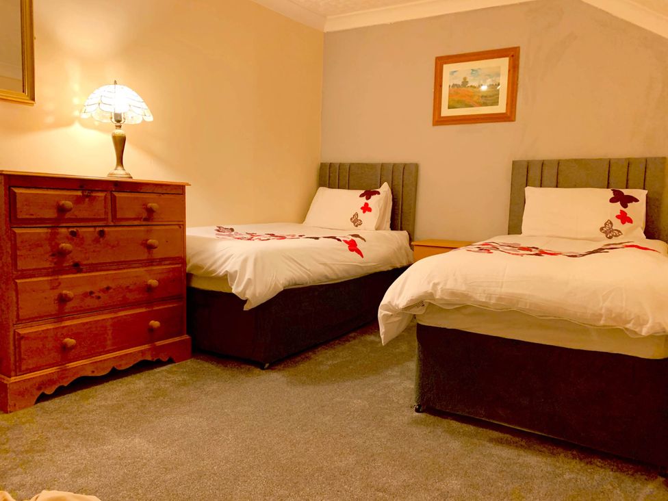 A bedroom with two beds and a drawer at Tanygrisiau near Blaenau Ffestiniog