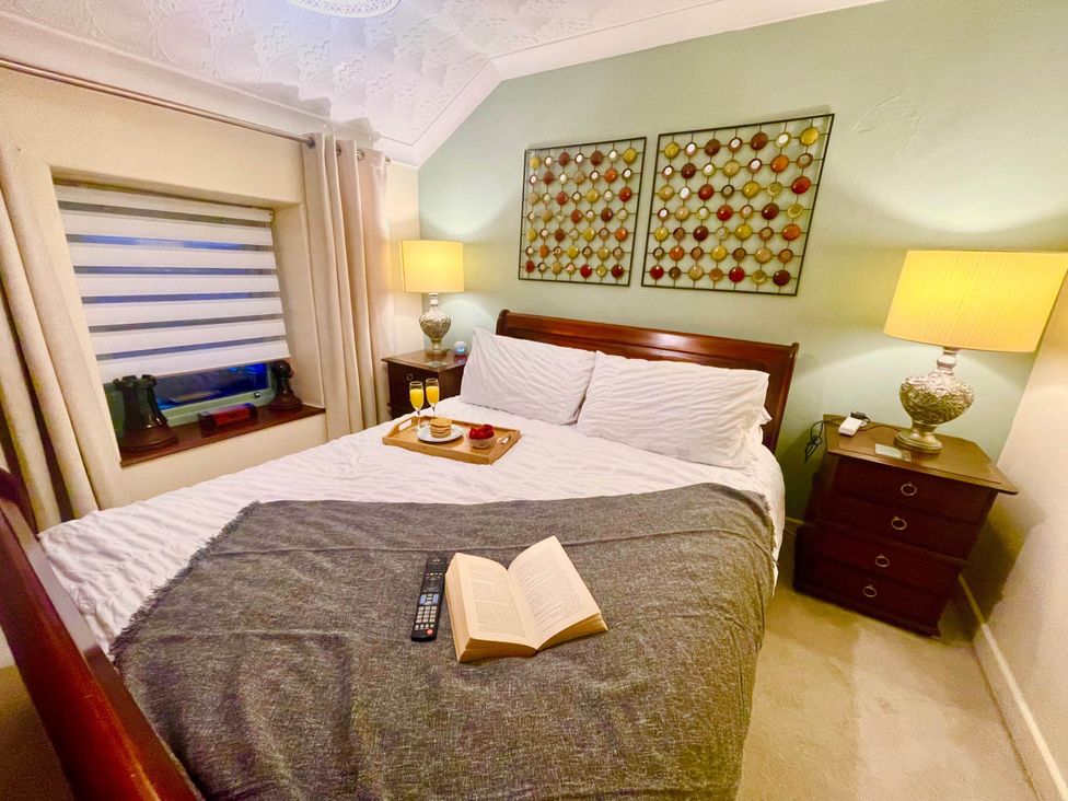 A bedroom with a bed and side table at Tanygrisiau near Blaenau Ffestiniog