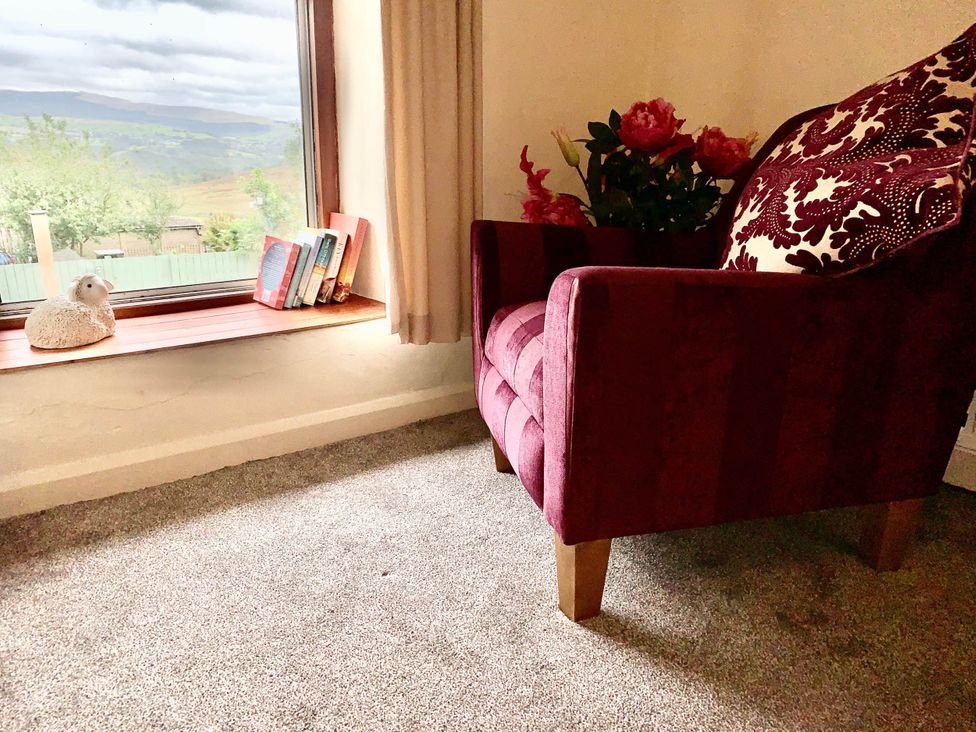 A living room with an armchair and a window at Tanygrisiau near Blaenau Ffestiniog