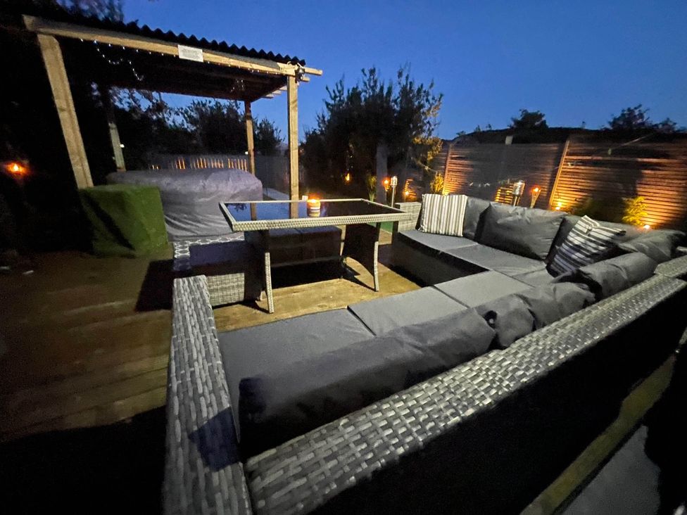 An outdoor seating area with a hot tub at Tanygrisiau near Blaenau Ffestiniog