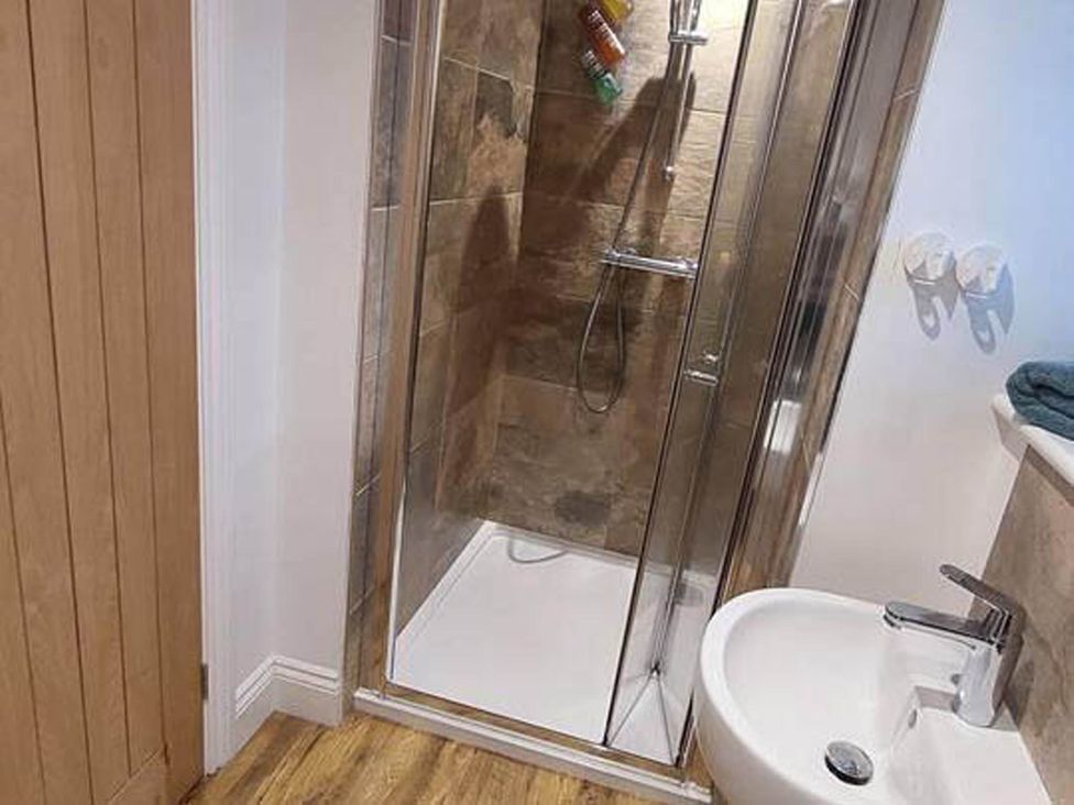 A bathroom with a shower and sink at The Old Barn in Hawkshead