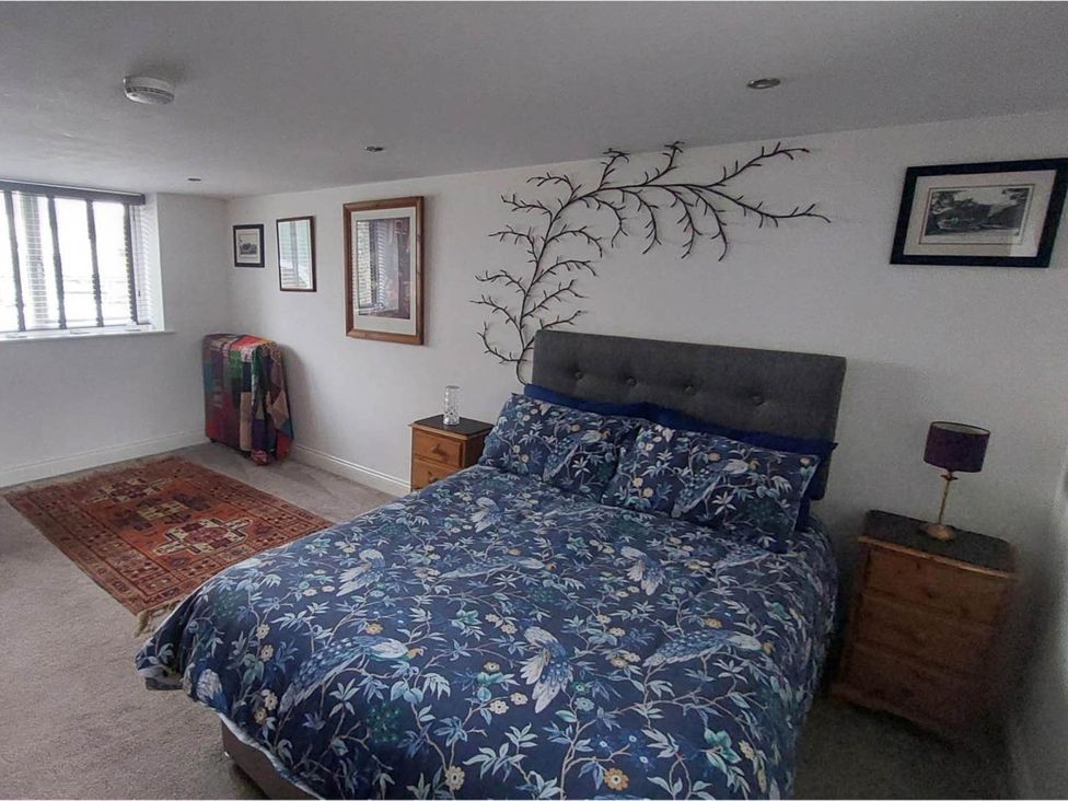 A bedroom with a bed and bedside table at The Old Barn in Hawkshead