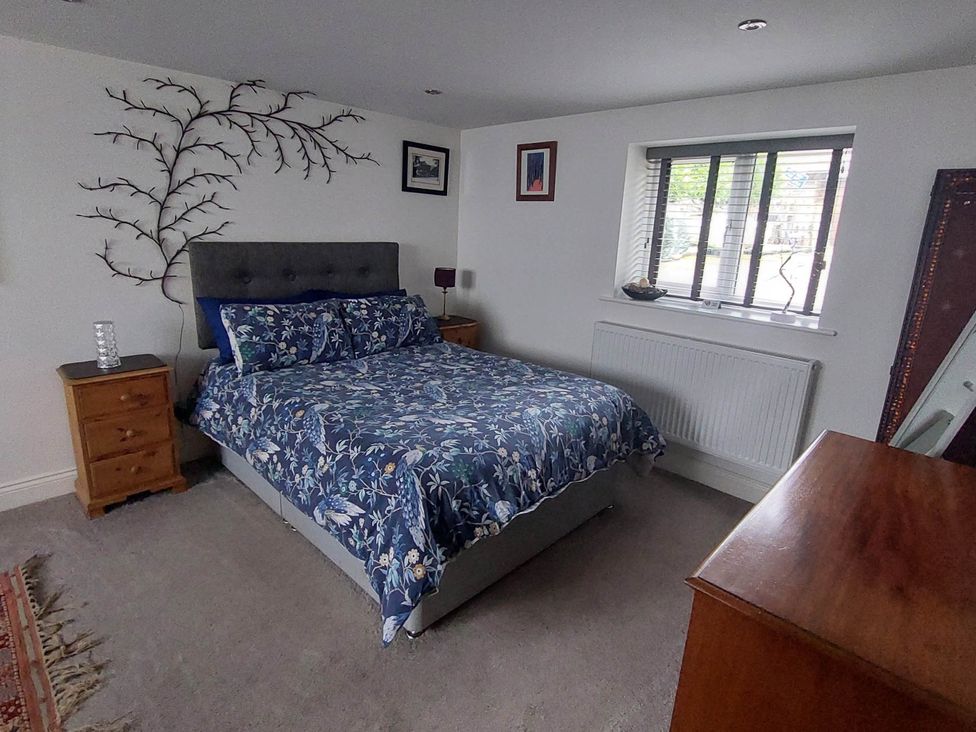 A bedroom with a bed and bedside table at the property in Hawkshead