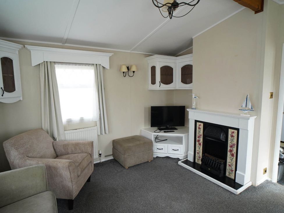 A living room with an armchair and television at 