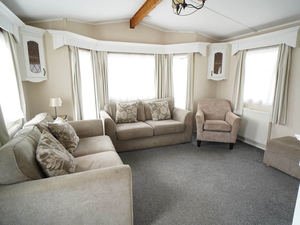 A living room with a sofa and armchair at The Old Barn in Manchester