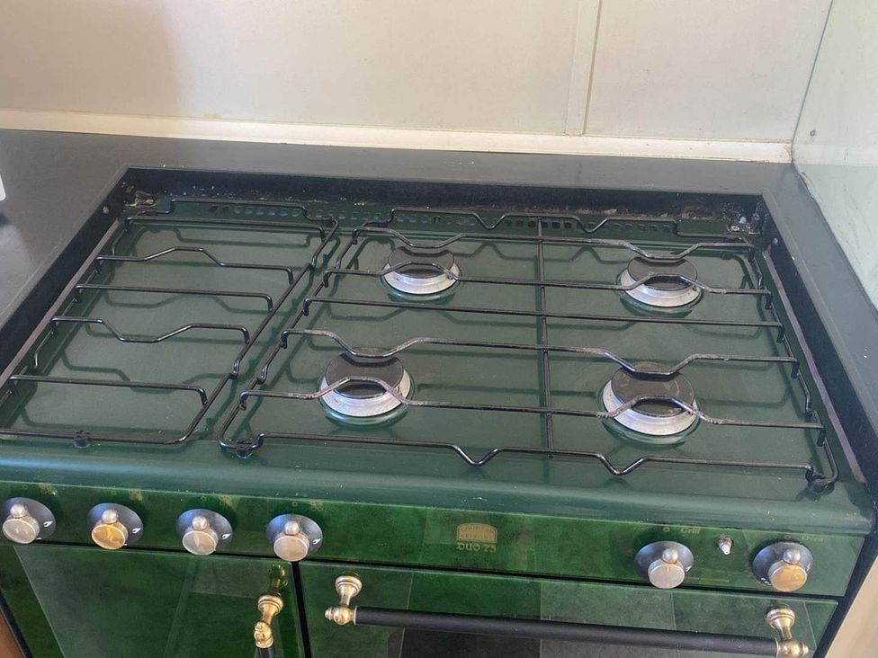 A gas stove with burners and control knobs at 