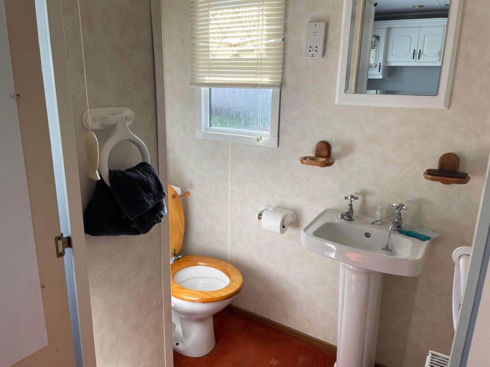 A bathroom with a toilet and sink at 