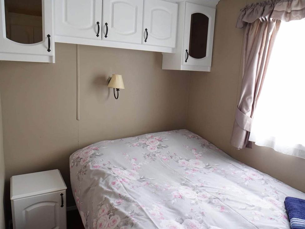 A bedroom with a bed and wardrobe at 