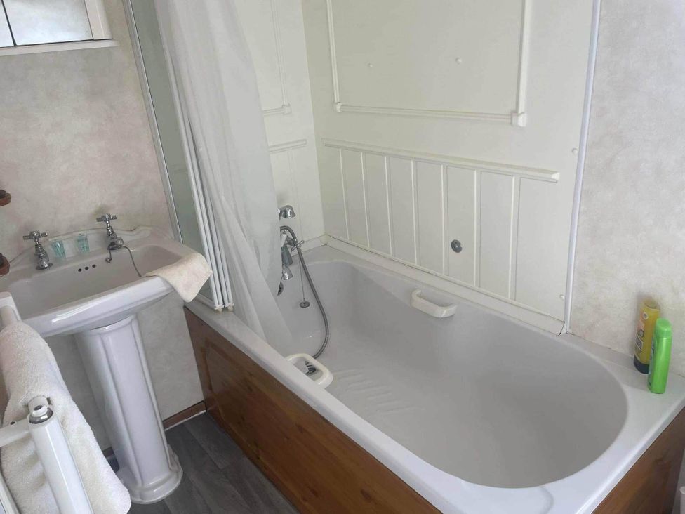 A bathroom with a bathtub and sink at 