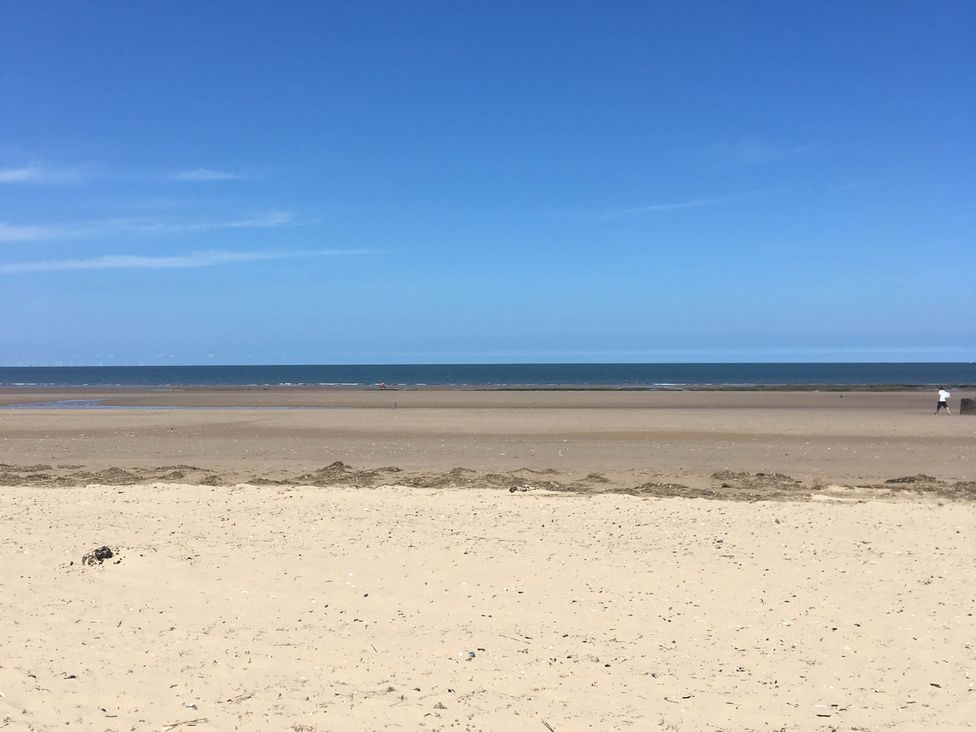 A beach with sand and ocean at a seaside location