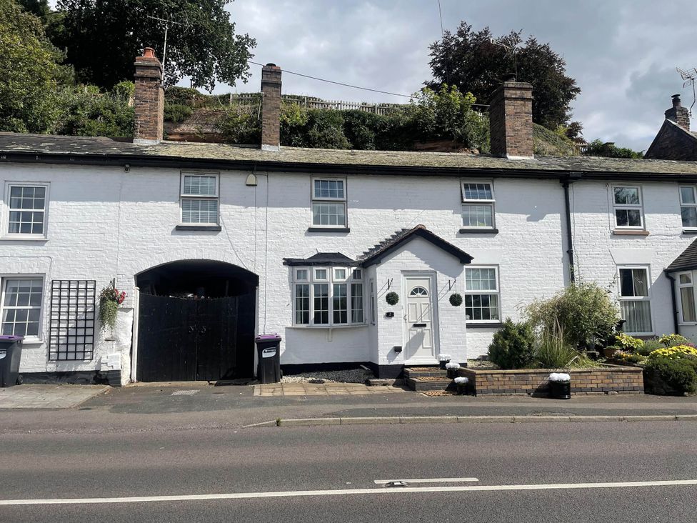 A house with a door and windows in a garden at Immaculate 3Bed House in Bridgnorth