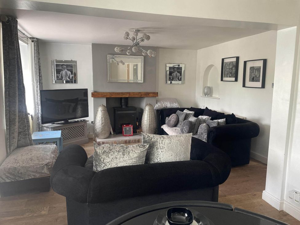 A living room with a sofa and television at Immaculate 3Bed House in Bridgnorth