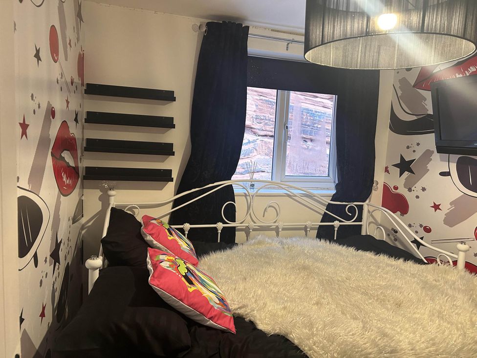 A bedroom with a bed and shelves at Immaculate 3Bed House in Bridgnorth