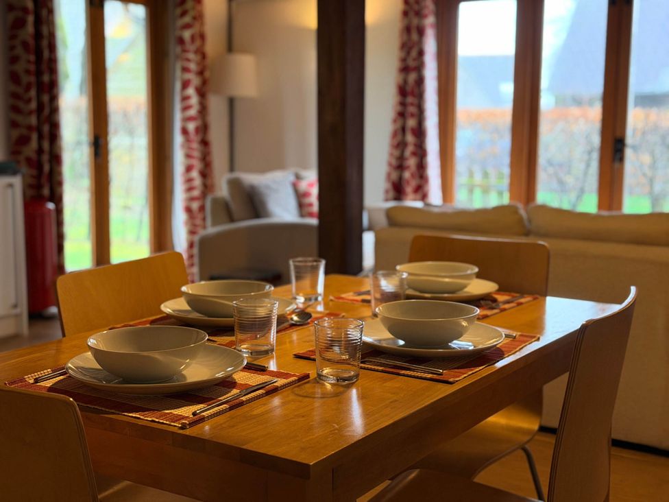 A dining area with a table set for four at Tremail near Camelford