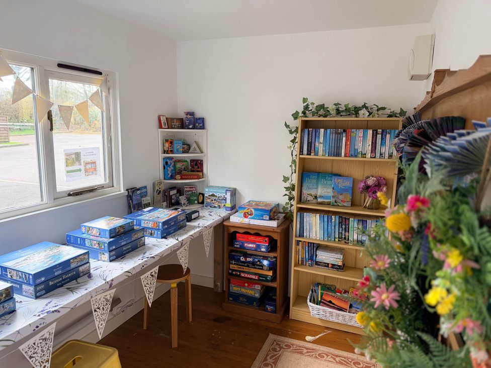 A room with puzzles and books on shelves at Tremail near Camelford