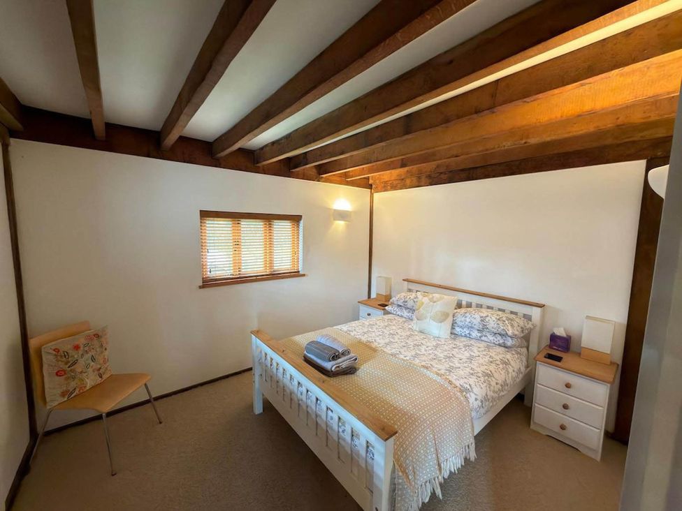A bedroom with a bed and bedside tables at Tremail near Camelford