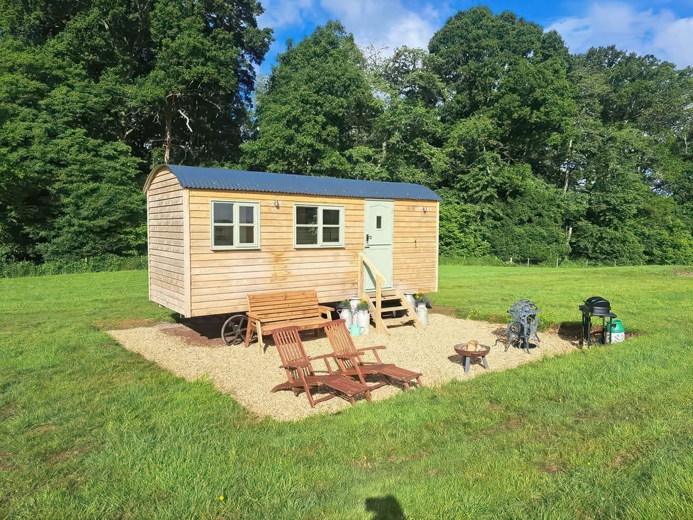A shed with chairs and a fire pit in an outdoor area near Bishop's Waltham