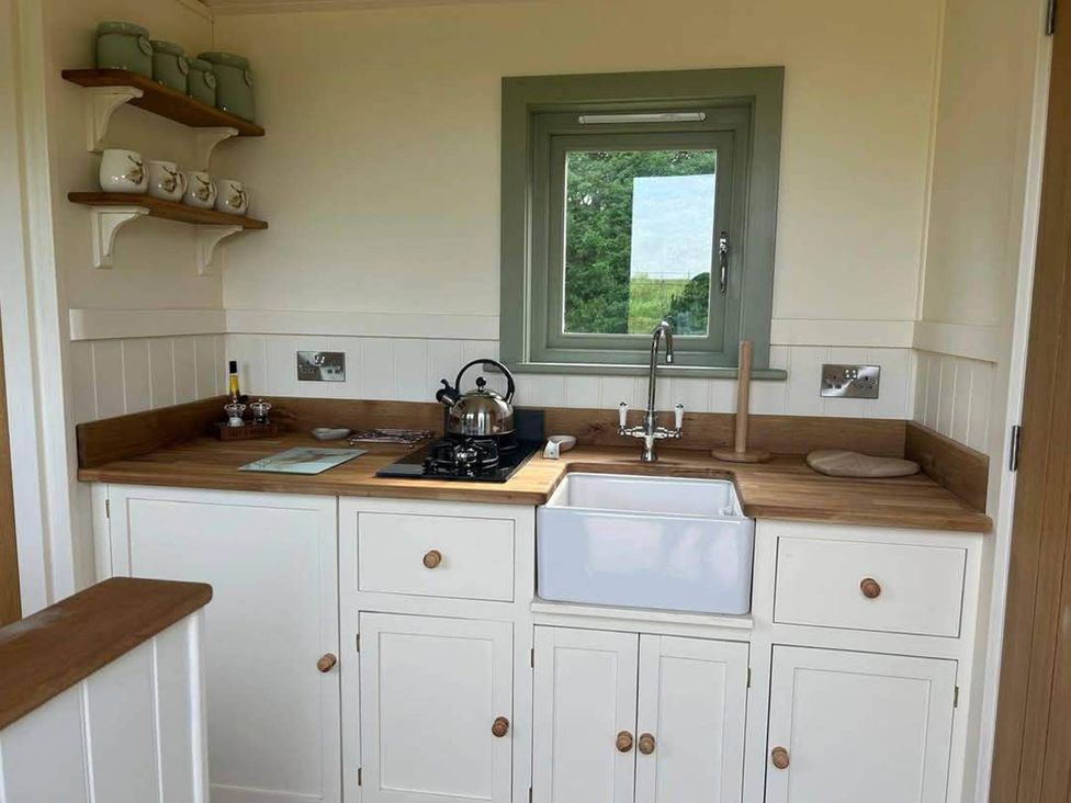 A kitchen with a sink and stove at 