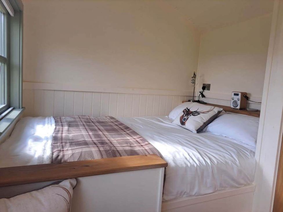 A bedroom with a bed and a radio at a property near Bishop's Waltham