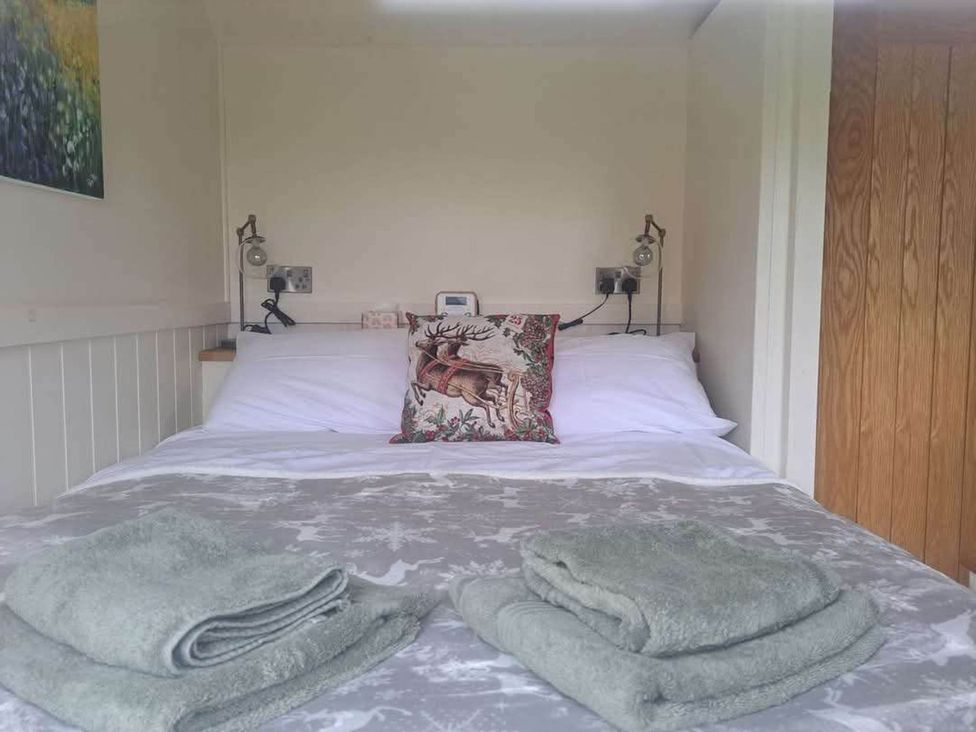 A bedroom with a bed and towels at 