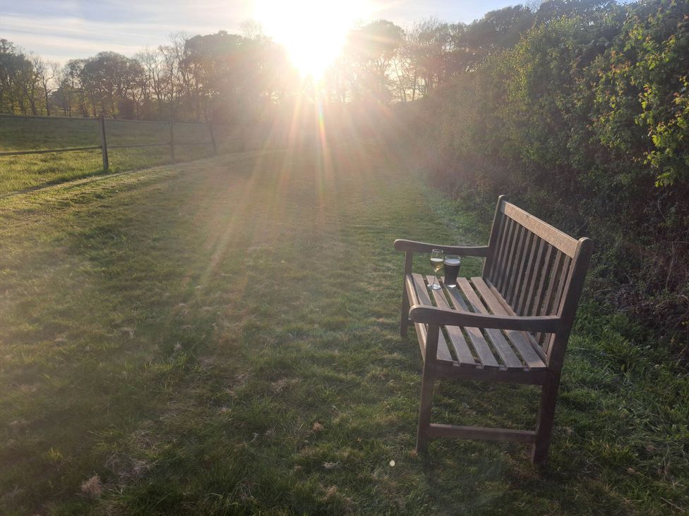 A bench with glasses on it in a garden near Bishop's Waltham