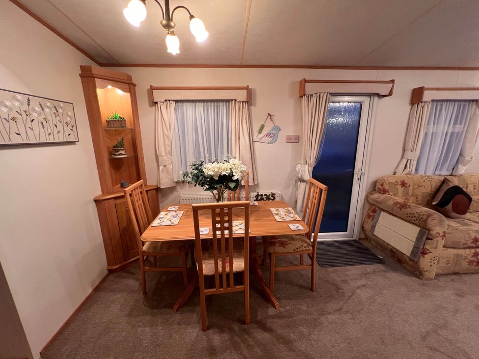 A dining room with a table and chairs at The Old Barn Near West Mersea