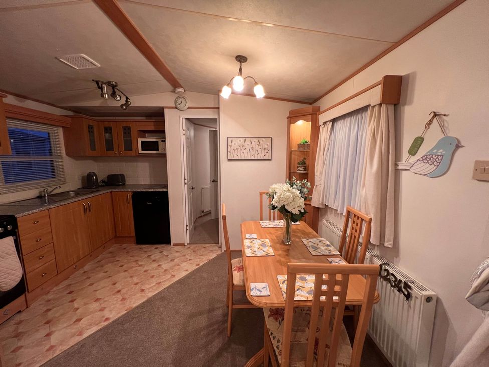 A kitchen with a dining table and chairs at the property near West Mersea