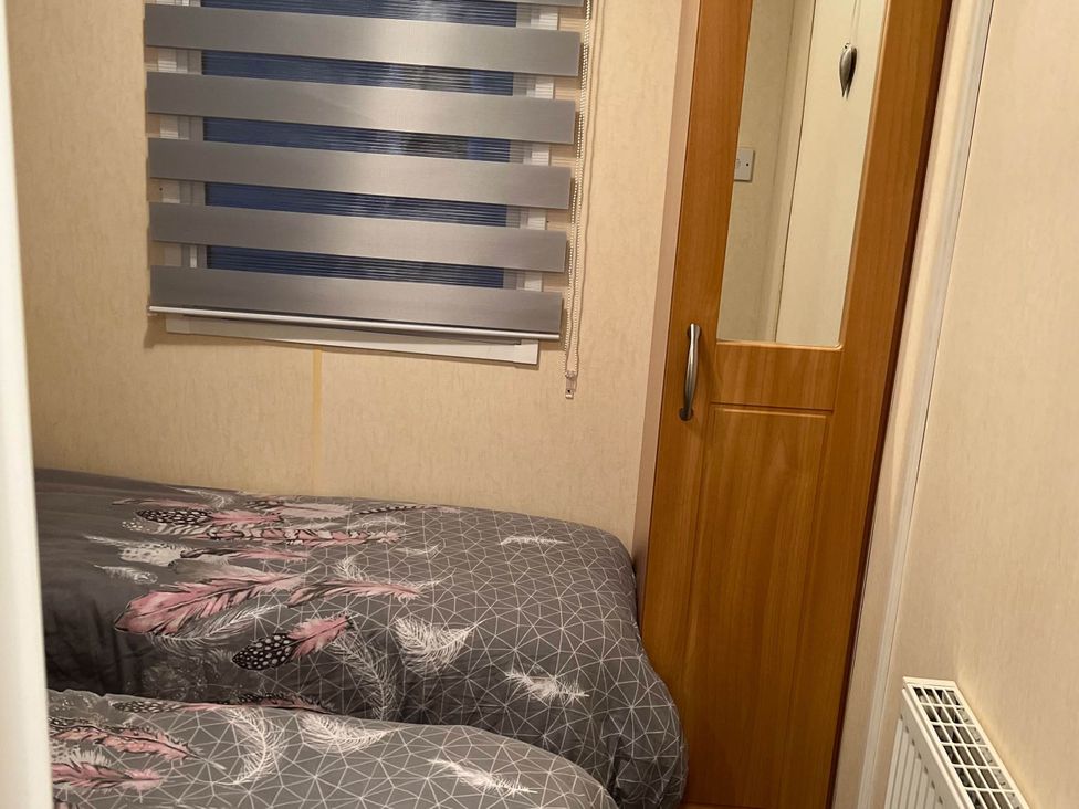 A bedroom with two beds and a door at 
