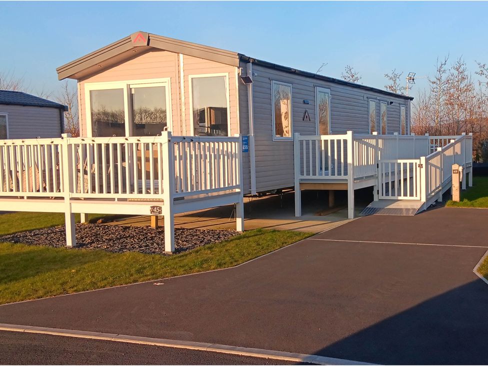 A mobile home with a deck and ramp at property near Flookburgh