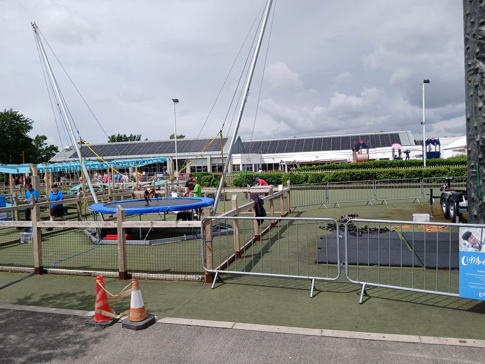 An outdoor play area with a trampoline and safety equipment near Flookburgh