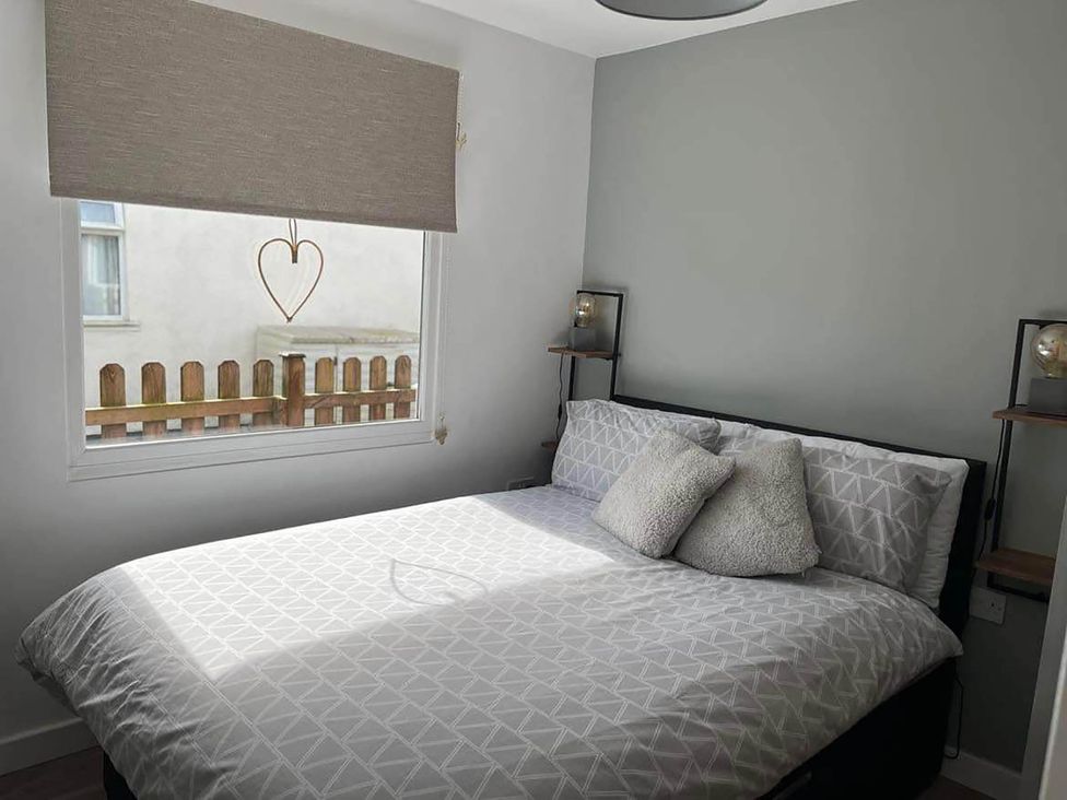 A bedroom with a bed and window at the property in Bridlington