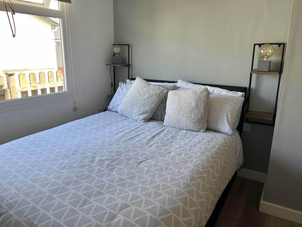 A bedroom with a bed and nightstand at 