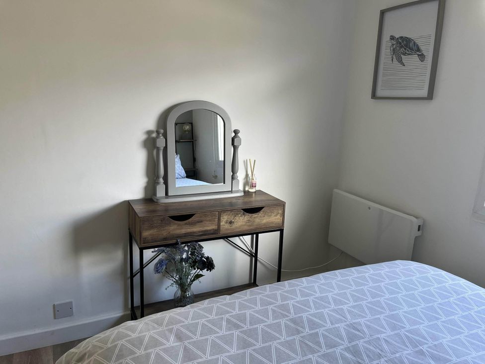 A bedroom with a vanity table and mirror at the property in Bridlington