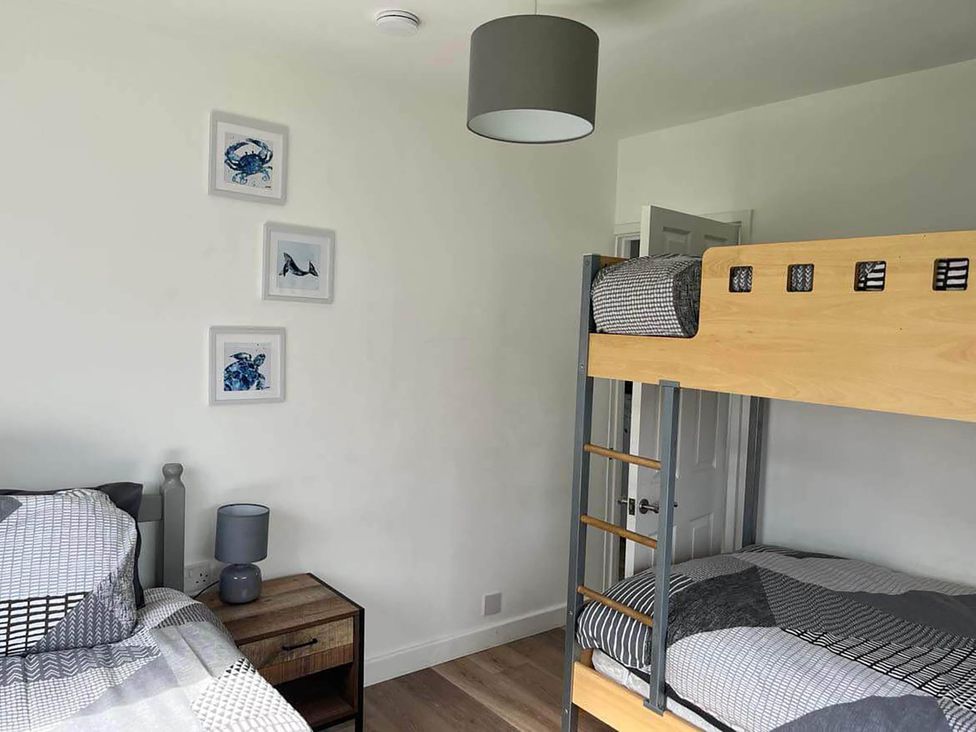 A bedroom with a bunk bed and a single bed at The Old Barn in Bridlington