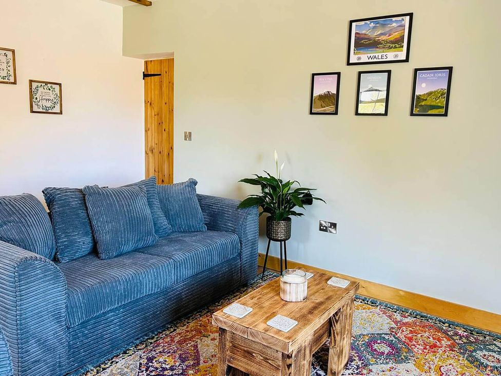 A living room with a sofa and coffee table at Nebo near Penygroes
