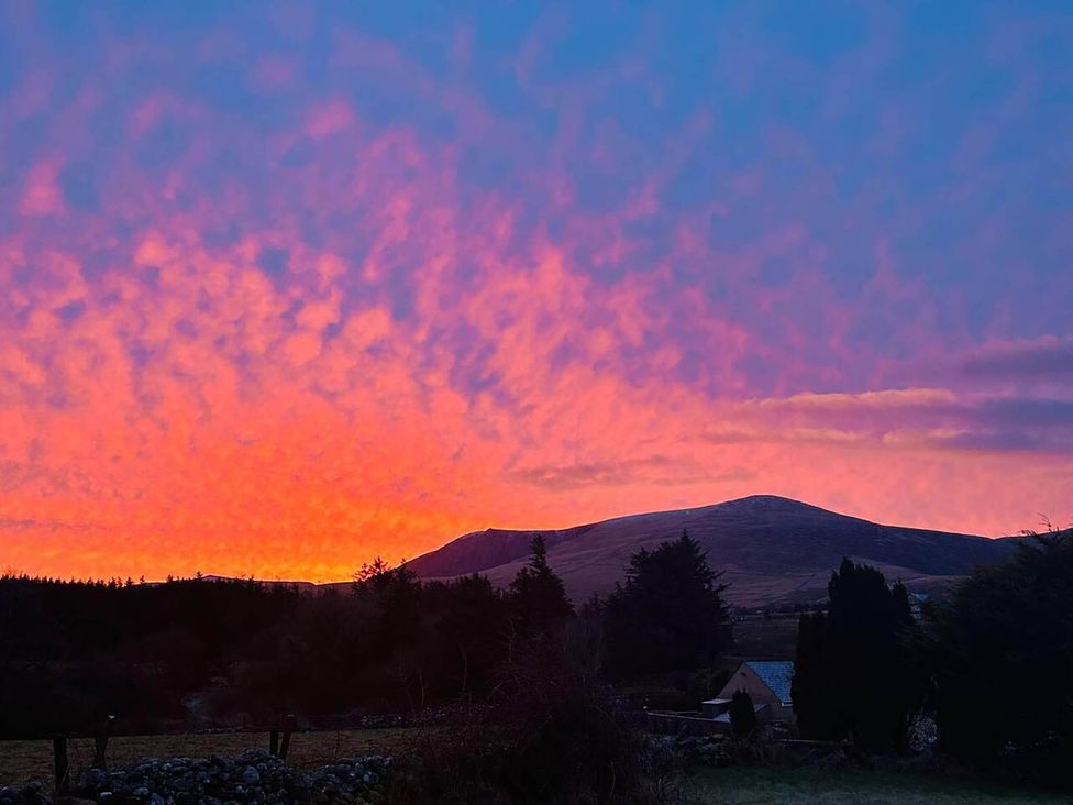 A landscape with mountains and colorful sky at Nebo near Penygroes