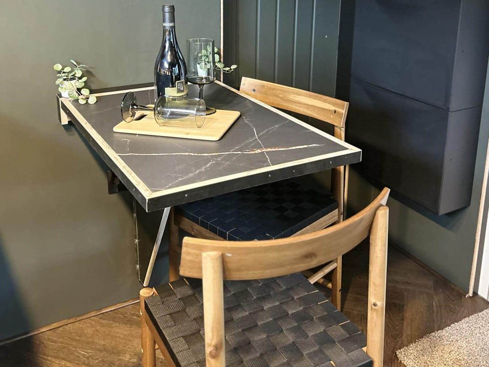 A dining table with wine and glasses at a property in Newton Abbot