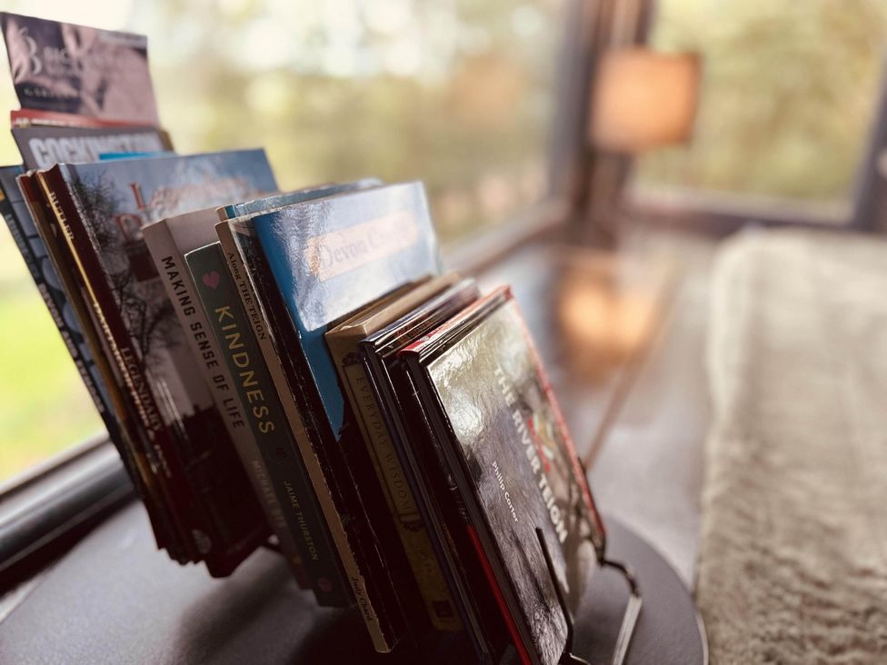 A collection of books on a display shelf in a reading nook at the property in Newton Abbot