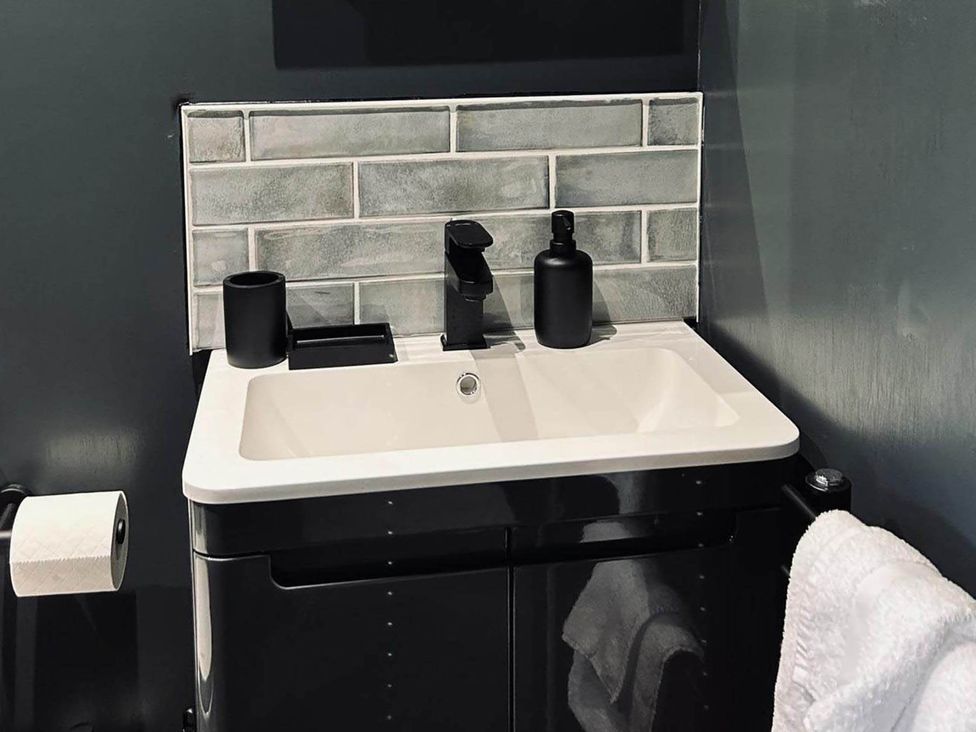 A sink with faucet and soap dispenser at the property in Newton Abbot
