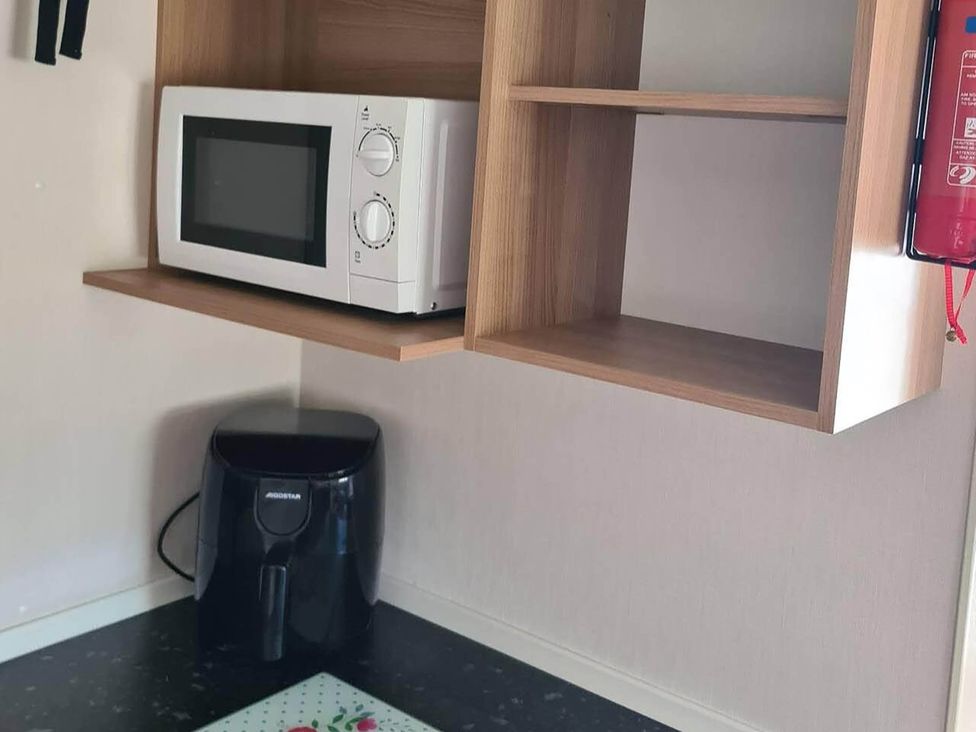 A kitchen with a microwave and air fryer at 