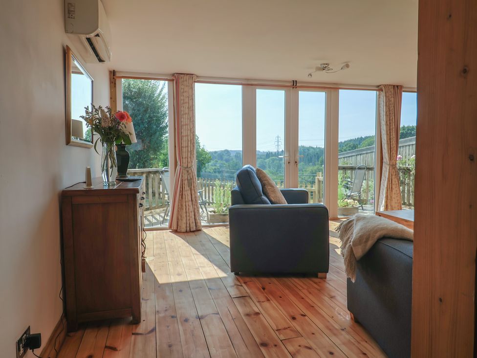 A living room with a sofa and window view at The Linhay Cotleigh Nr. Honiton