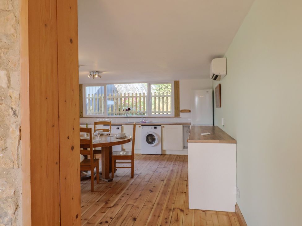 A kitchen with a table and chairs at The Linhay Cotleigh Nr. Honiton